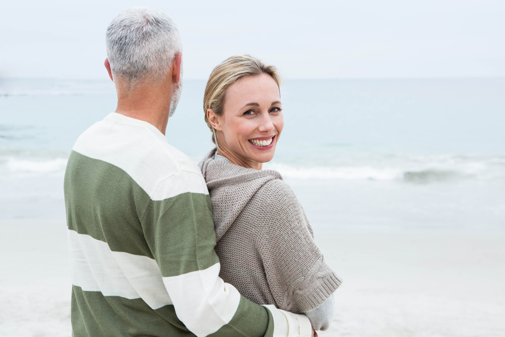 Woman hugging her partner at the beach